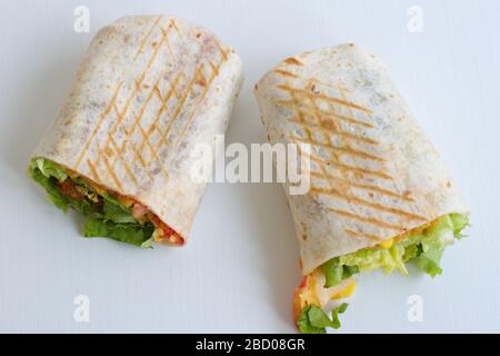 Tortilla with fried chicken meat and vegetables isolated on white background Stock Photo
