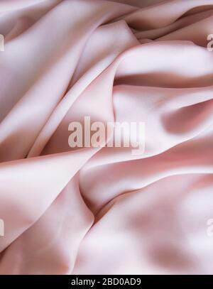 Pink silk gentle texture clothes. Textile cloth background. Stock Photo