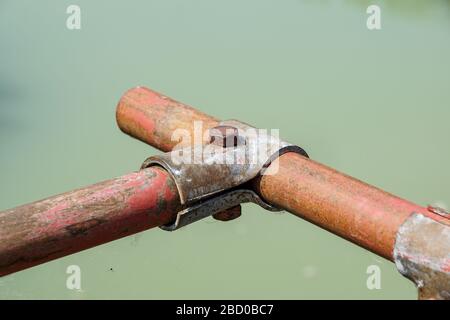 Scaffolding pipe clamp and parts, An important part of building strength to scaffold clamps in used close up on construction site,platforms for stage Stock Photo