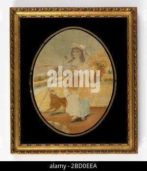 Embroidered picture. Research in ProgressOval picture of shepherdess carrying crook and basket in a rural landscape with a sheep at her feet. With gold rectangular frame with black eglomisé glass Embroidered picture Stock Photo
