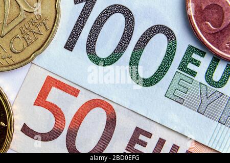 50 and 100 euros close-up. Euro cents are located on the sides. investment concept. banking Stock Photo