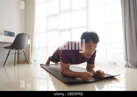asian man doing workout sport plank at home Stock Photo