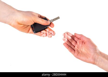 Person hands over car keys isolated on a white background Stock Photo