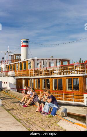 People enjoying he sun in the harbor of Kiel, Germany Stock Photo