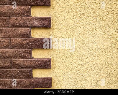 Wall with ceramic tiles in the form of stone bricks. Stock Photo