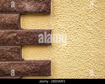 Wall with ceramic tiles in the form of stone bricks. Stock Photo