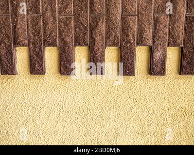 Wall with ceramic tiles in the form of stone bricks. Stock Photo