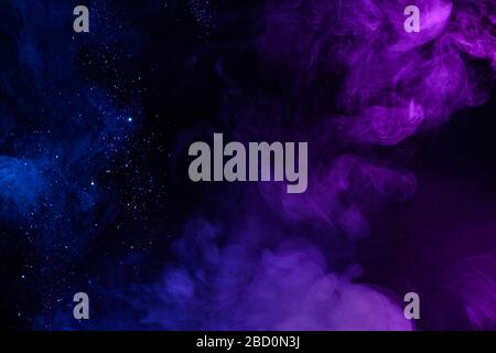 Shiny glitter in clouds of pink and blue fog smoke abstract background Stock Photo