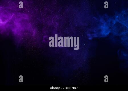 Colorful smoke fog clouds with shiny dust sparkles of glitter on black background Stock Photo