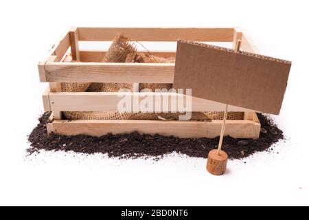 blank label tag and empty rustic box and topsoil with cardboard square tag. Price tag, gift tag, sale tag,  label isolated on white background Stock Photo