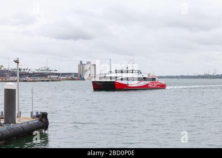 Southampton, United Kingdom - April 24, 2019: Fast passenger ferry arrives the port of Southampton. MV Red Jet 7 is a high-speed Catamaran ferry of Re Stock Photo