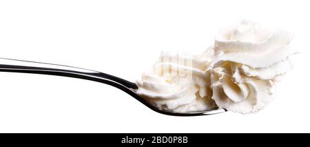 white cream on a spoon isolated on white background Stock Photo