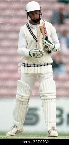 The Oval, London 19 May 1990. Surrey v Hampshire. Surrey openin batsman, Grahame Clinton's bat breaks from a delivery by Hampshire's Kevin Shine as David Gower looks on. Stock Photo