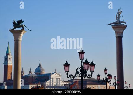 Venice, Italy-February 2020; View from high standpoint of top part of a number of iconic statues, lantarns and buildings in Venice on the lagoon again Stock Photo