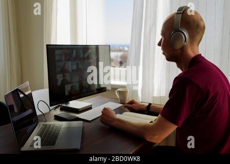 Man working from home. Having a video call with his team Stock Photo