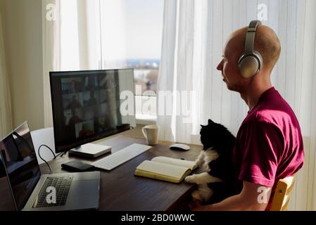 Man working from home. Having a video call with his team Stock Photo