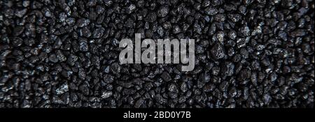 Many small black stones. Background, texture of small stones, gravel. Stones texture. Stock Photo