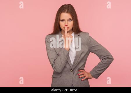 I don't believe, you are liar! Portrait of dissatisfied young woman in business suit touching nose showing lie gesture, suspecting cheating, body lang Stock Photo