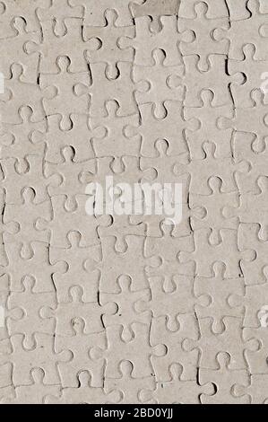 Abstract background formed by image of blank reverse side of a completed jigsaw puzzle. Stock Photo