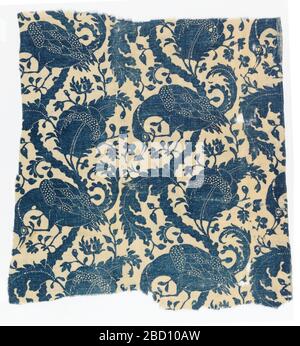 Textile. Research in ProgressDark blue resist print on a white ground. Design shows serpentine branches with ornamental foliage and perching bird. White dots used to suggest detail in the foliage and on birds. Textile Stock Photo