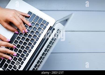 Close up female hands typing on laptop keyboard. Stock Photo