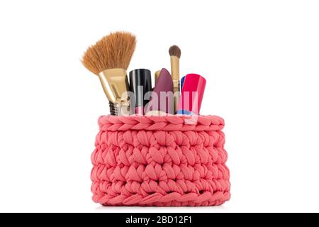 beautiful red knitted handmade female cosmetics full of makeup isolated on white background Stock Photo