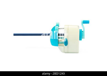 school mechanical pencil sharpener ready to sharpen a blue pencil isolated on white background Stock Photo