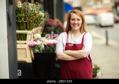 florist outside her shop Stock Photo