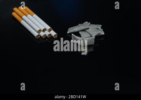 Nicotine products of various types. Cigarettes - smoking tobacco and snus - chewing tobacco Stock Photo