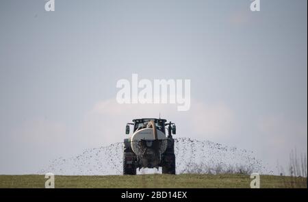 Erkenbrechtsweiler, Germany. 04th Apr, 2020. A farmer fertilizes a meadow. Credit: Sebastian Gollnow/dpa/Alamy Live News Stock Photo