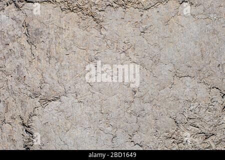 Texture of the wall of an old wooden house made of clay and straw. Stock Photo