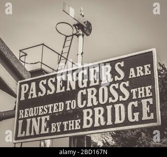 Old-fashioned, sepia close up of vintage railway sign and signal, Bewdley vintage train station, Severn Valley Railway heritage line, UK. Stock Photo