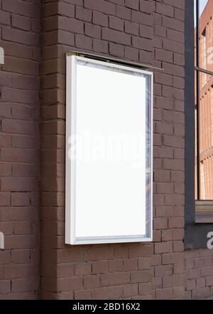 Blank white glass rectangular poster mockup brick wall mounted Stock Photo