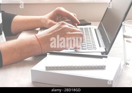 Freelancer works on a laptop in the home office Stock Photo