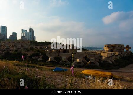 Raouche, Lebanon - May 05, 2017: Numerous acropode blocks stored at the shore. Acropodes are manmade concrete blocks used to resist the action of sea. Stock Photo