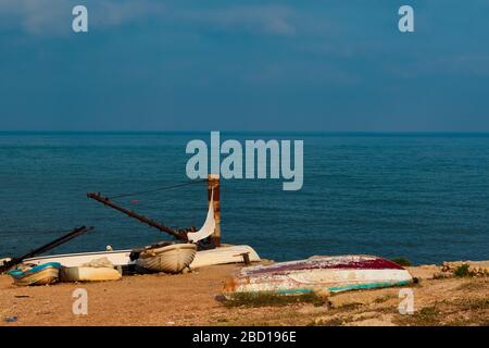 Raouche, Lebanon - May 05, 2017: Old fishing boats left behind at the shore in Raouche. Stock Photo