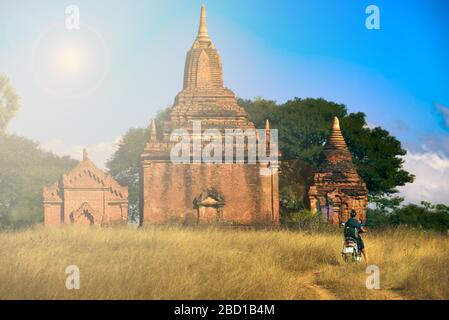 Tourist Visiting Myanmar - Young Woman exploring city of Bagan on electric scooter Stock Photo