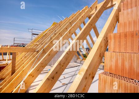 Roof beams on an unfinished building in construction Stock Photo