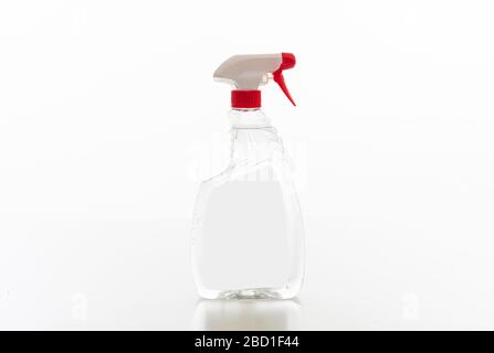 Cleaning spray bottle clear with red trigger isolated against white background. Chemical detergent product no name template, blank empty label, copy s Stock Photo