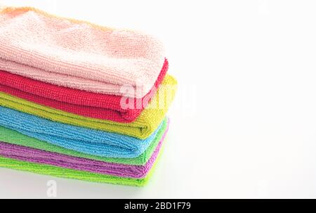 Cleaning towels microfiber cloth isolated against white background, Folded cleaning textile napkins colorful stack. Domestic household cleaning Stock Photo
