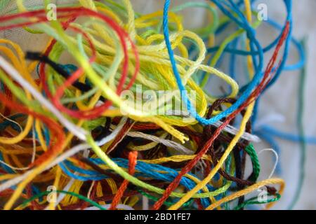 A tangle of multi coloured offcuts of embroidery thread, background texture photo Stock Photo