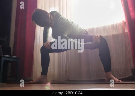 Sporty girl doing sumo squat exercises or revolved temple, Goddess Stock Photo