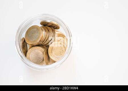 Top view of 1 Turkish Lira (TRY) coins in a jar on isolated on white background. Money growth and deposit accumulation concept. Stock Photo