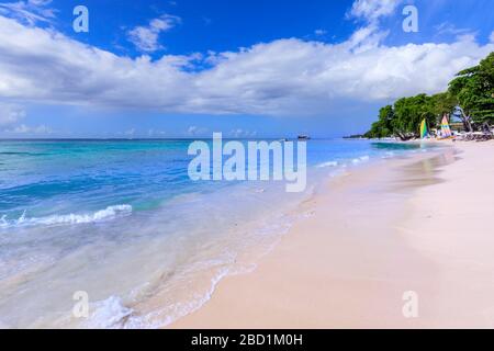 Paynes Bay, small colourful sail boats pulled up on fine pale pink sand beach, beautiful West Coast, Barbados, Windward Islands, Caribbean Stock Photo