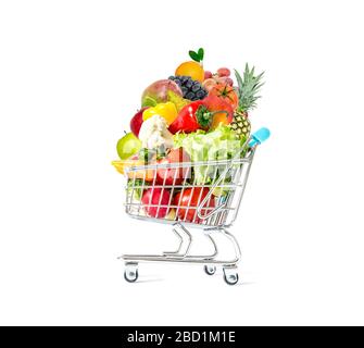 Fresh vegetables and fruits in a crowded shopping cart isolated on a white background. Mountain of fresh vegetables and fruits in a crowded trolley is Stock Photo