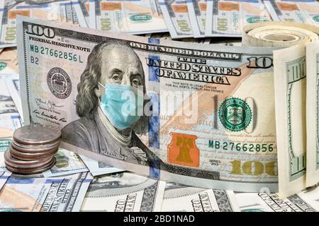 Coronavirus in USA. 100 dollar money bills with medical face mask, Stock Photo