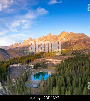 Aerial view of deforestation surrounding Carezza Lake after the violent Vaia storm, Dolomites, South Tyrol, Italy, Europe Stock Photo