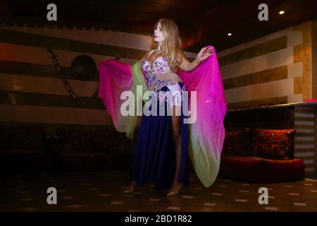 Beirut, Lebanon - May 30, 2017: Graceful mature woman of Lebanese origin performing belly dance with veil. Stock Photo