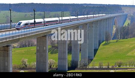 06 April 2020, Thuringia, Grümpen: An ICE train crosses the Grümpental Bridge, a 1104-meter-long structure on the new Munich - Berlin line. With an arch span of 270 metres, it is the longest arched railway bridge in Germany and was completed in 2011. More than half of the more than 25,700 railway bridges in Germany were built before the end of the Second World War, 45 percent are older than 100 years. Photo: Martin Schutt/dpa-Zentralbild/dpa Stock Photo