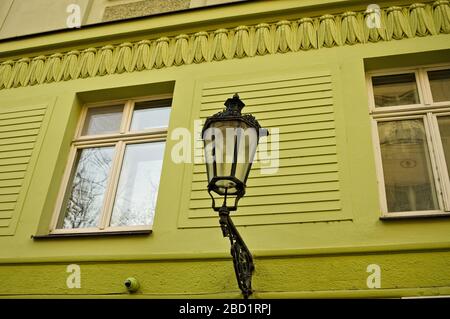 Isolated black street lantern hanging on a green wall (Prague, Czech Republic, Europe) Stock Photo